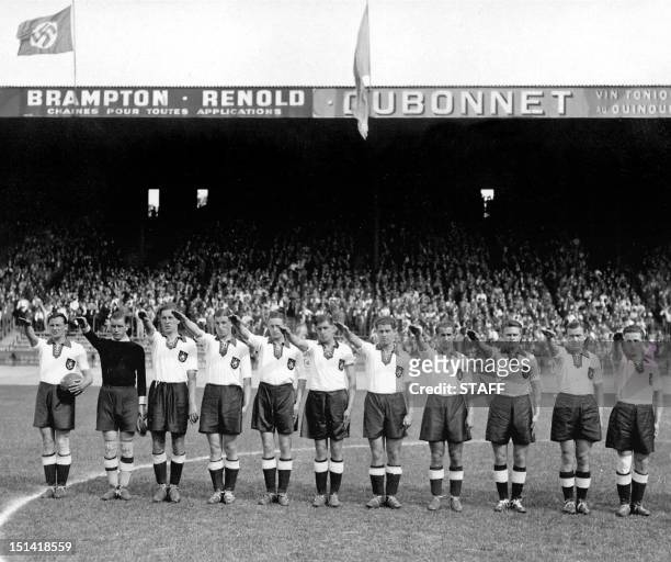 German national soccer team players execute the nazi salute, 04 June 1938 at the Parc des Princes stadium in Paris, before the start of their World...
