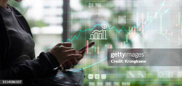 interactive graphs and charts portraying financial success - ingreso fotografías e imágenes de stock