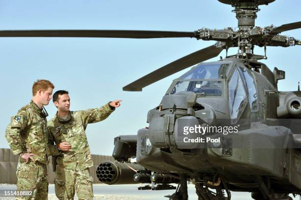 Prince Harry is shown the Apache flight-line by a member of his squadron at Camp Bastion on September 7, 2012 in Helmand Province, Afghanistan....