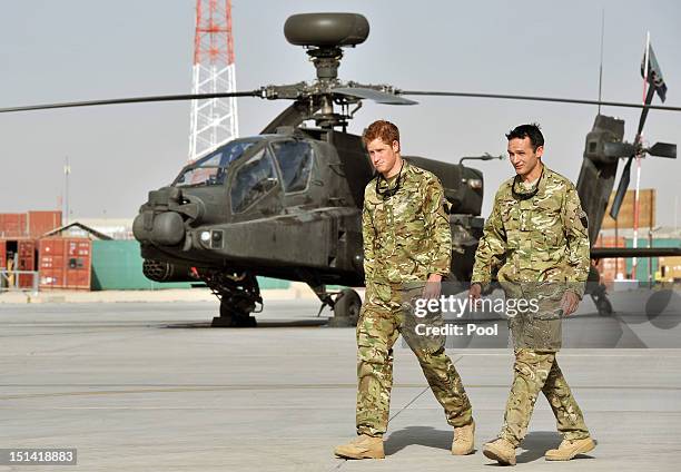 Prince Harry is shown the Apache flight-line by a member of his squadron at Camp Bastion on September 7, 2012 in Helmand Province, Afghanistan....