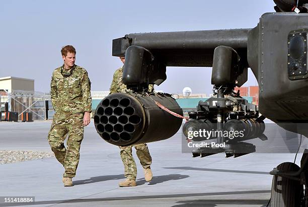 Prince Harry is shown the Apache flight-line by a member of his squadron at Camp Bastion on September 7, 2012 in Helmand Province, Afghanistan....