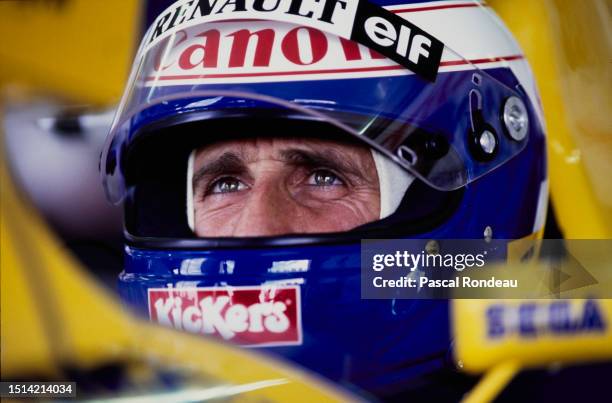 Alain Prost from France checks the lap times from the cockpit of the Canon Williams Renault Williams FW15C Renault V10 during practice for the...