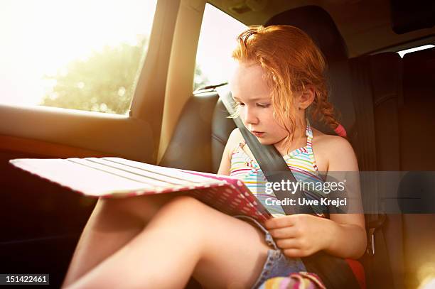 girl (4 - 6 years) playing on digital tablet - girl in car with ipad stock pictures, royalty-free photos & images