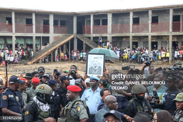 Local residents gather to greet Paris Saint Germain striker and France captain Kylian Mbappe during a visit to the Bonendale's bilingual public...