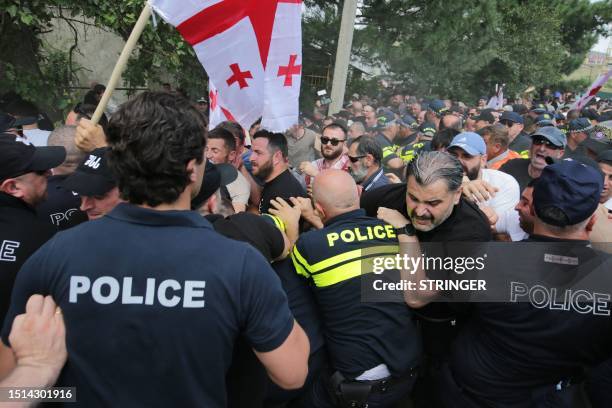 Anti-LGBTQ+ activists clash with police as they try to interfere with a gathering of LGBTQ+ community for the Tbilisi Pride Festival in Tbilisi on...