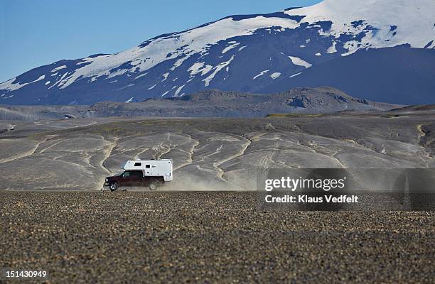 car driving past the volcano hekla - off highway vehicle stock pictures, royalty-free photos & images