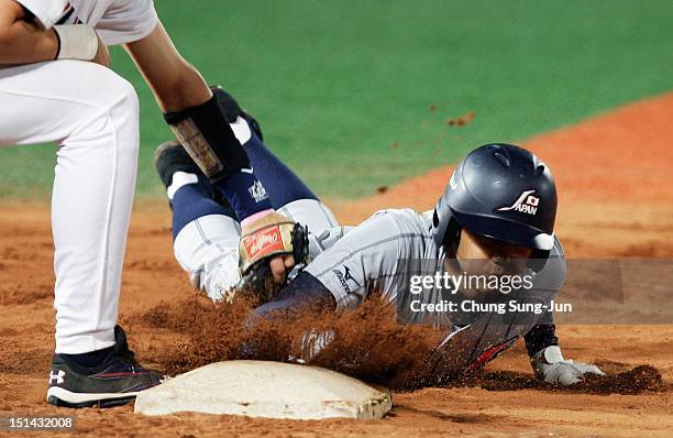 Cavan Biggio of United States tags out Shohei Otani of Japan as he slides into first base in the fifth inning during the U18 Baseball World...