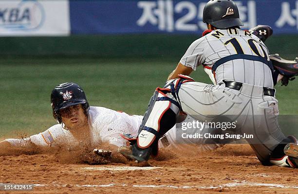 Tomoya Mori of Japan tags out William Abreu of United States as he slides into home in the second inning during the U18 Baseball World Championship...