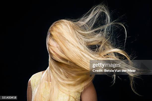 woman covered with blowing hair in wind. - blond haar stockfoto's en -beelden