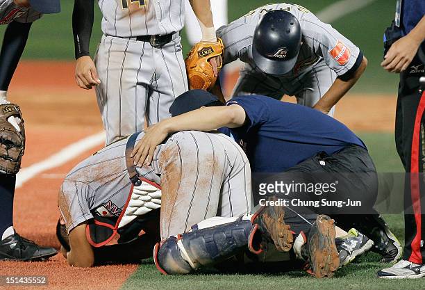 Tomoya Mori of Japan reacts after a collision with Reese McGuire of United States in the seventh inning during the U18 Baseball World Championship...