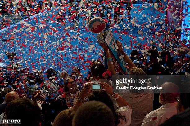 September 6: Delegates from Wisconsin tear down their sign as a keepsake after President Barack Obama and Vice President Joe Biden celebrate on stage...
