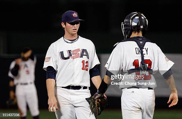 Kevin Davis of United States talks with Chris Okey in the eighth inning during the U18 Baseball World Championship match between Japan and the United...