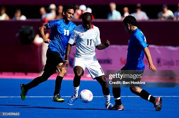 Ibz Diallo of Great Britain is put under pressure by Matias Fernandez Romano and Fabio Coria of Argentina during the Men's 7-a-side football 5-8...
