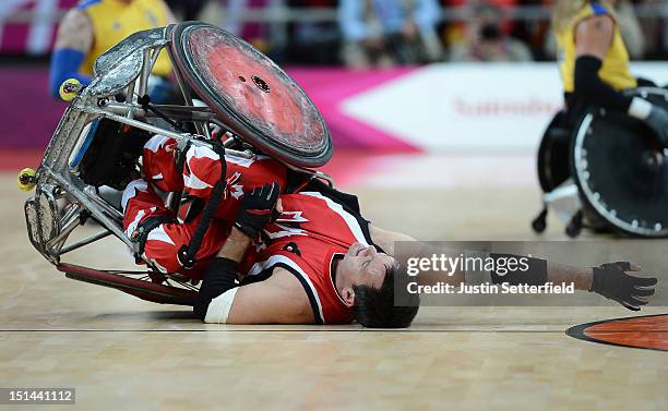 Mike Whitehead of Canada falls to the floor during the Mixed Wheelchair Rugby - Open match between Canada and Sweden on Day 9 of the London 2012...