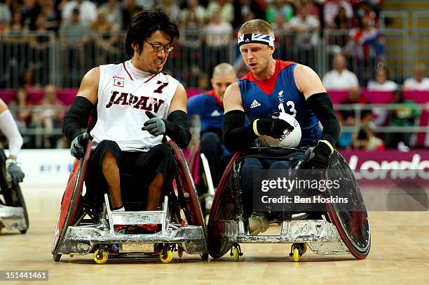 Aaron Phillips of Great Britain holds off pressure from Daisuke Ikezaki of Japan during the Men's Pool Phase Group A match between Great Britain and...