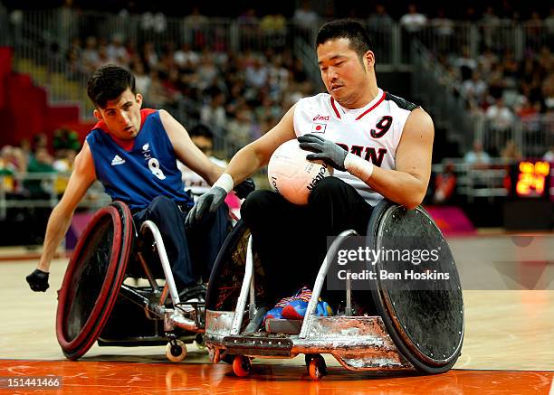 Manabu Tamura of Japan scores a point as Myles Pearson of Great Britain looks on during the Men's Pool Phase Group A match between Great Britain and...