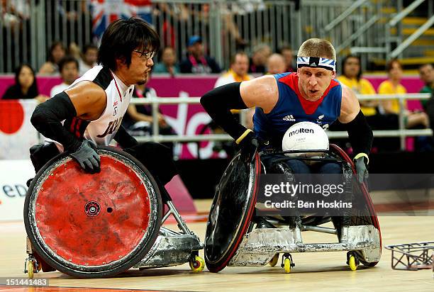 Aaron Phillips of Great Britain holds off pressure from Daisuke Ikezaki of Japan during the Men's Pool Phase Group A match between Great Britain and...