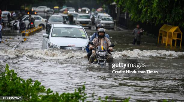 Traffic moves through a water logged street after the Heavy rains at Supreme Court of India on July 8, 2023 in New Delhi, India. Delhi-NCR was...