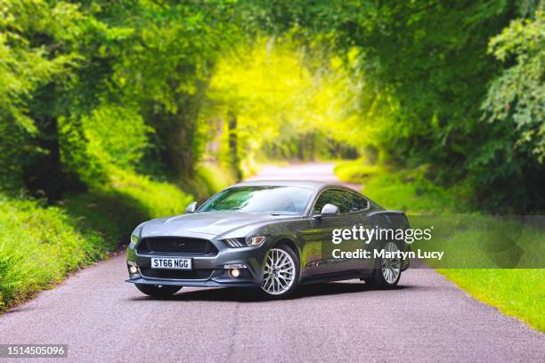 The Ford Mustang GT shot on a back road in Devon, United Kingdom. The Mustang GT is a 5-litre V8 American muscle car, now sold in the European...