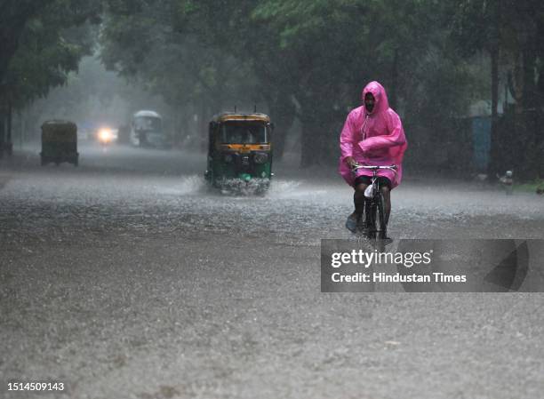 Vehicles wades through water logged streets after heavy rainfall at Bangla Sahab Marg on July 8, 2023 in New Delhi, India. Delhi-NCR was drenched...