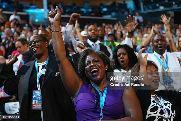 Attendees sing and dance as musician James Taylor performs on stage during the final day of the Democratic National Convention at Time Warner Cable...