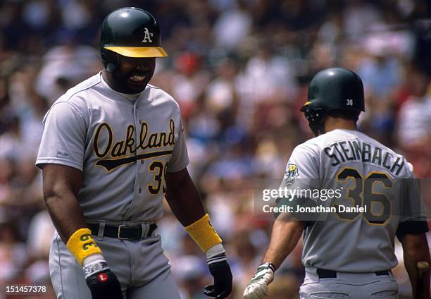 Dave Parker of the Oakland Athletics walks by teammate Terry Steinbach during an MLB game against the Milwaukee Brewers in July, 1989 at Milwaukee...