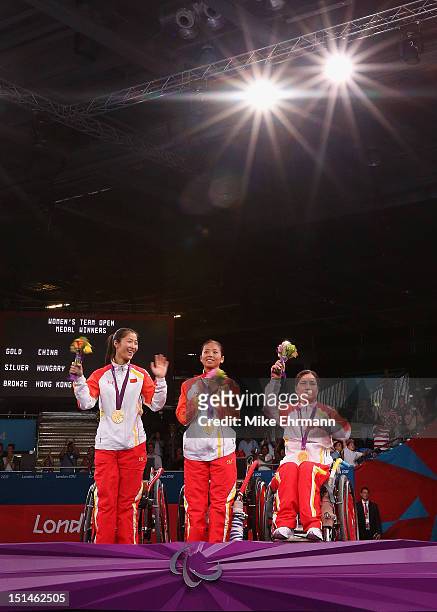 Jing Rong, Baili Wu, and Fang Yao of China celebrate winning the Gold Medal in the Women's Team Wheelchair Fencing on day 9 of the London 2012...