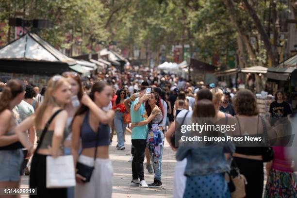 People stroll along Las Ramblas on June 30 in Barcelona, Catalonia, Spain. Catalonia was Spain's second most popular tourist destination between...