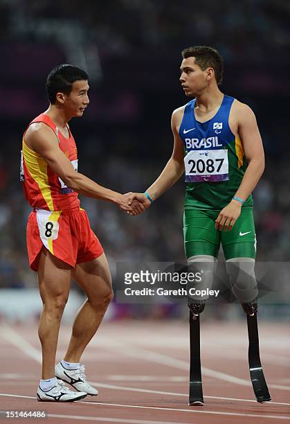 Alan Oliveira Cardoso Oliveira of Brazil shakes hands with Zhiming Liu of China after the Men's 400m T44 heats on day 9 of the London 2012 Paralympic...