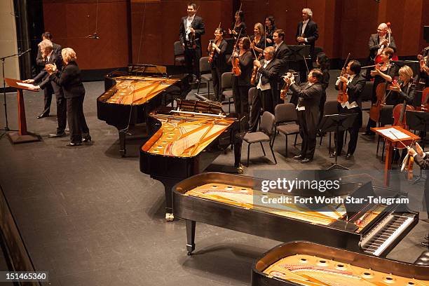 Van Cliburn, left, takes the stage prior to his 50th anniversary concert in Dallas, Texas, on September 6, 2012.