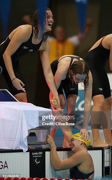 Ellie Cole and Annabelle William of Australia celebrate with teammates Jacqueline Freney after winning the gold in the Women's 4x100m Medley Relay -...