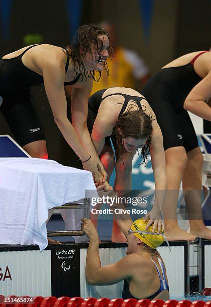 Ellie Cole and Annabelle Williams of Australia celebrate with teammates Jacqueline Freney after winning the gold in the Women's 4x100m Medley Relay -...