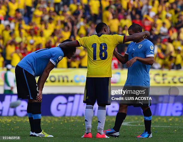Colombia's defender Juan Camilo Zuniga comforts Uruguay's forward Edinson Cavani and midfielder Walter Gargano after defeating them 4-0 in a Brazil...