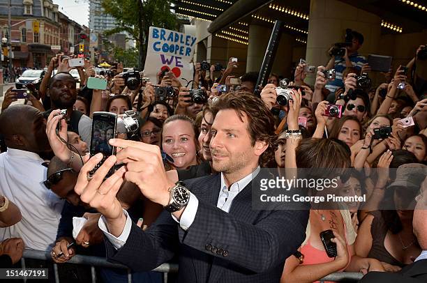Bradley Cooper poses for a photo with fans at "The Place Beyond The Pines" premiere during the 2012 Toronto International Film Festival at Princess...