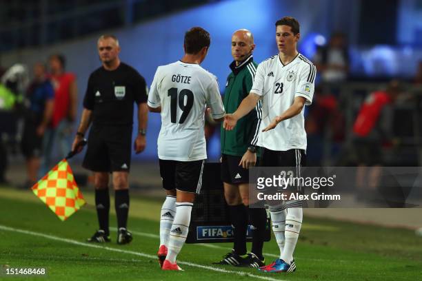 Mario Goetze of Germany is substituted by Julian Draxler during the FIFA 2014 World Cup qualifier group C match between Germany and Faeroe Islands at...