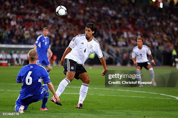 Daniel Udsen Faeroe Islands challenges Sami Khedira of Germany during the FIFA 2014 World Cup Qualifier group C match between Germany and Faeroe...