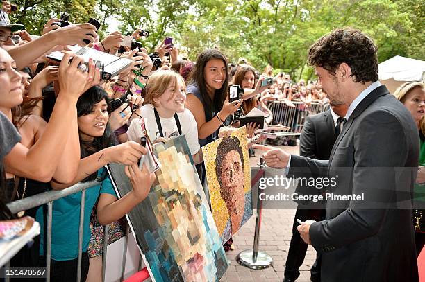 Actor James Franco looks at portraits of himself as he attends the "Spring Breakers" premiere during the 2012 Toronto International Film Festival at...