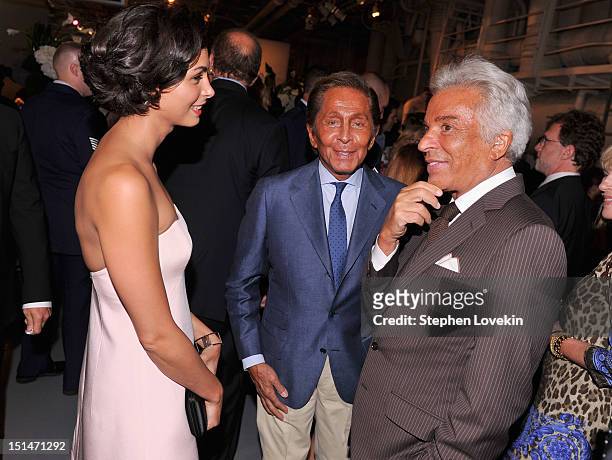 Actress Morena Baccarin, designer Valentino Garavani and honorary president of the Valentino Fashion House Giancarlo Giammetti attend the Showtime...