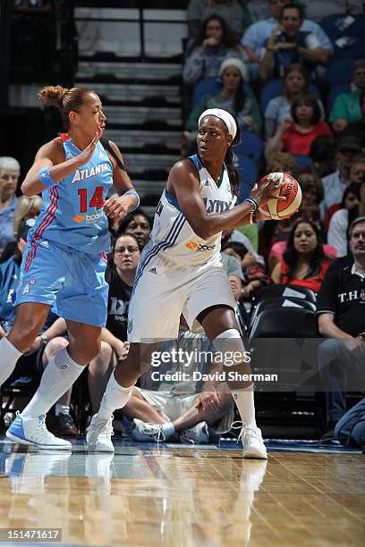 Taj McWilliams-Franklin of the Minnesota Lynx looks to pass the ball against Erika de Souza of the Atlanta Dream during the WNBA game on September 7,...