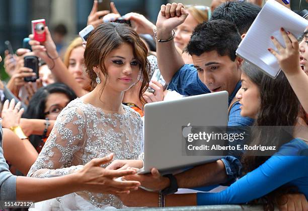 Actress Selena Gomez poses for photos with fans at the "Spring Breakers" premiere during the 2012 Toronto International Film Festival at Ryerson...