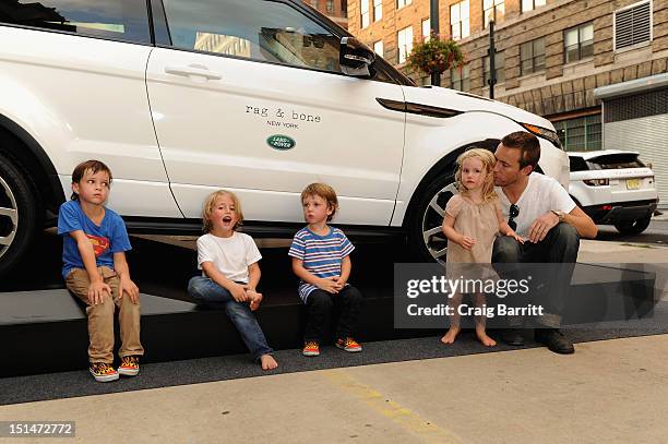 Designer David Neville and children pose in front of the Range Rover Evoque outside the Rag & Bone Spring 2013 fashion show, sponsored by Land Rover...