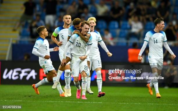 Cole Palmer of England celebrates his side's first goal with team mates, scored by teammate Curtis-Jones, not pictured, during the UEFA Under-21 EURO...