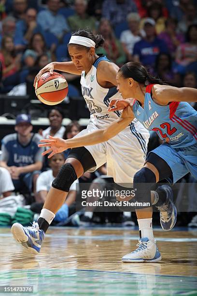 Maya Moore of the Minnesota Lynx dribbles the ball against Armintie Price of the Atlanta Dream during the WNBA game on September 7, 2012 at Target...