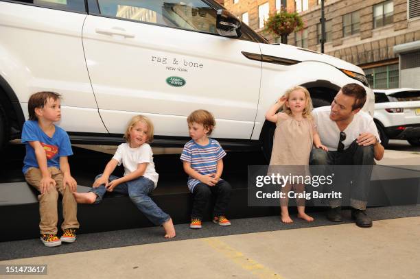 Designer David Neville and children pose in front of Range Rover Evoque outside the Rag & Bone Spring 2013 fashion show, sponsored by Land Rover on...