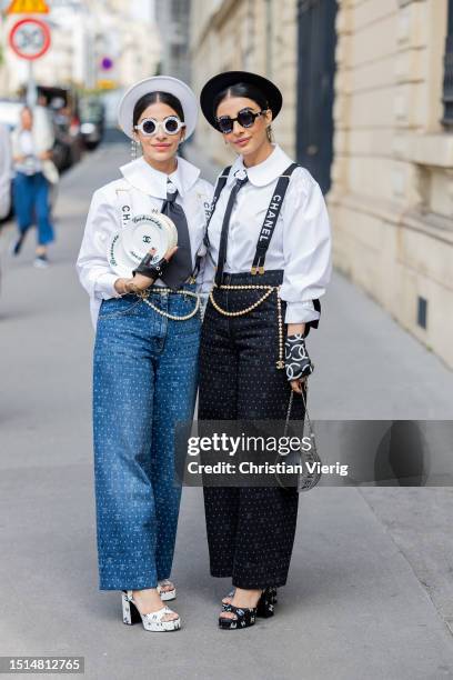 Twins seen wearing hat, sunglasses, high waisted pants, gloves, bag, sandals with logos outside Chanel during the Haute Couture Fall/Winter 2023/2024...