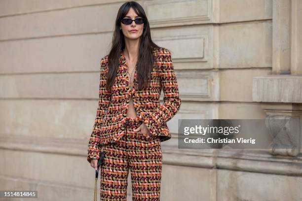 Leia Sfez is seen wearing knitted blazer, flared pants, mini bag, sunglasses outside Chanel during the Haute Couture Fall/Winter 2023/2024 as part of...