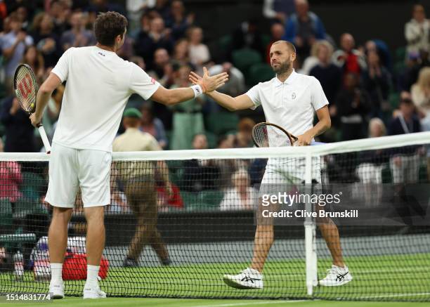 Daniel Evans of Great Britain shakes hands with Quentin Halys of France following the Men's Singles first round match during day two of The...