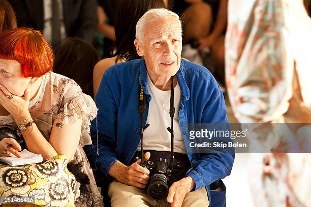 Contributing Fashion Editor for Vogue.com Lynn Yaeger and The New York Times fashion photographer Bill Cunningham watch a model on the runway at the...