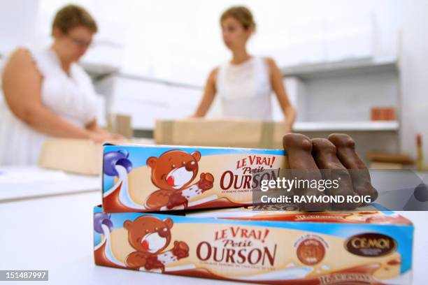 Boxes of chocolate coated marshmallow bears are displayed on a table, on August 23 at the factory of the French group CEMOI, specialized in the...