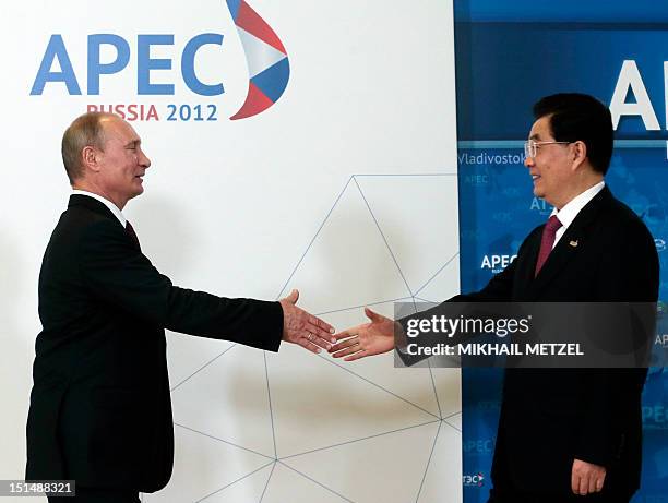 Russian President Vladimir Putin welcomes Chinese President Hu Jintao during the Asia-Pacific Economic Cooperation Summit in Russia's far eastern...